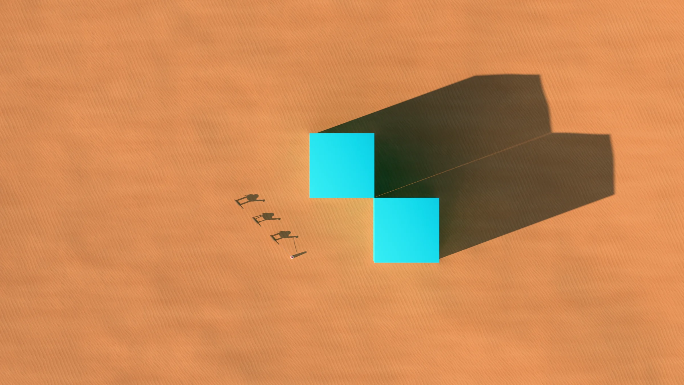 Two turquoise monoliths meeting at one corner in red sand, seen from above, with a camel caravan and their long shadows